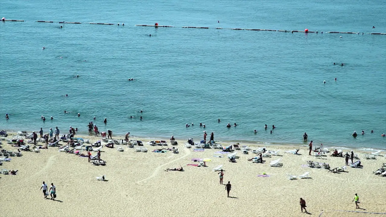 Crowd of Western Tourist on a private hotel seaside beach resort in South East Asia enjoying and relaxing in the hot sun sea sand vacation