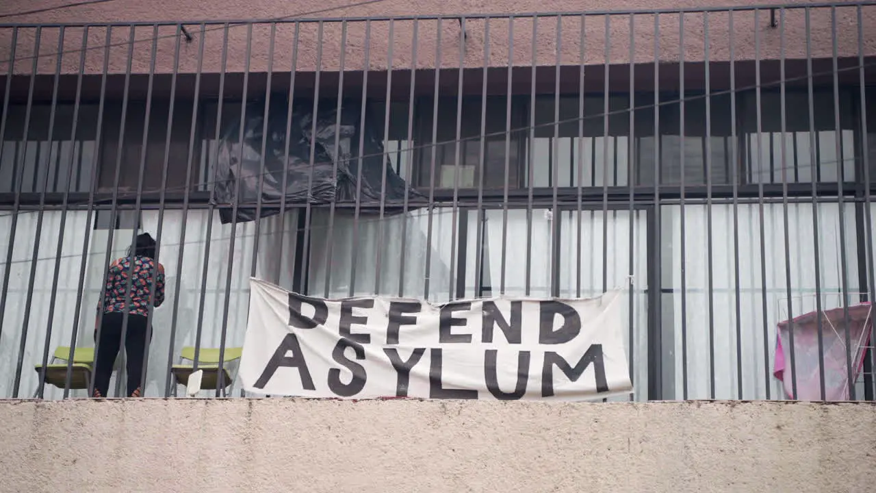 A sign saying Defend Asylum hangs over a clinic for migrants in Tijuana Mexico