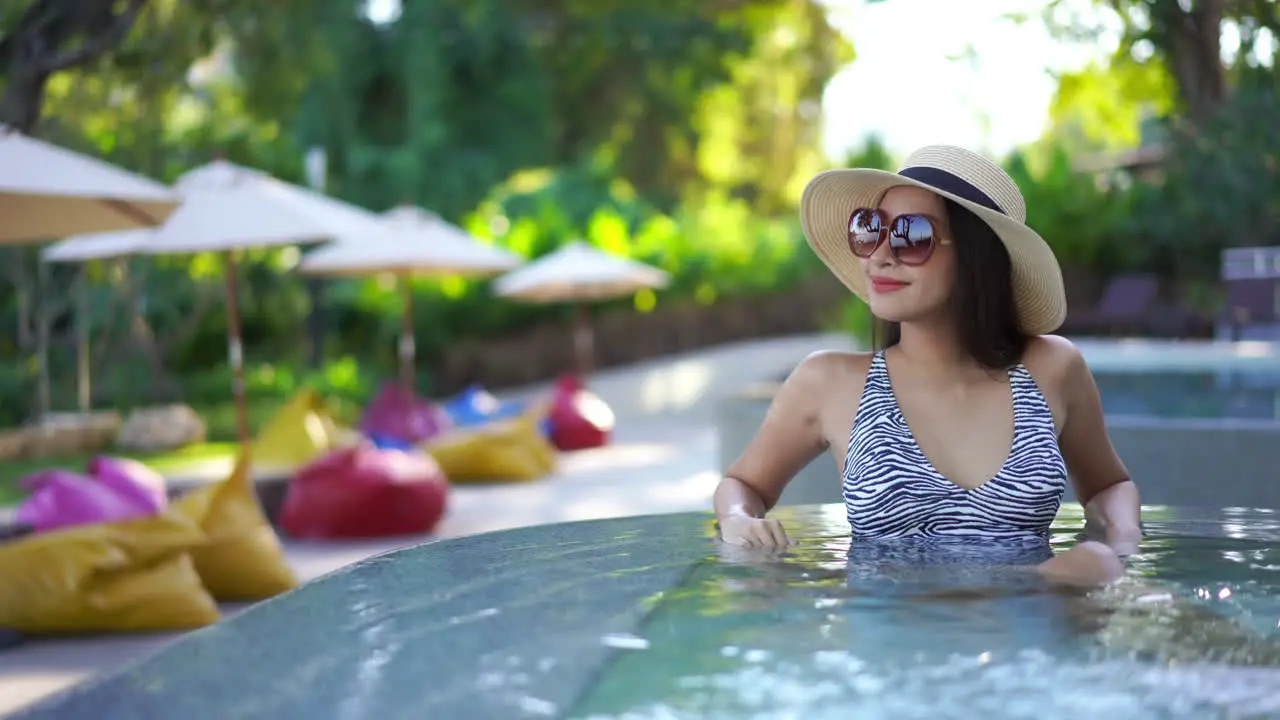 Elegant adult woman on holiday sitting in hot tub whirlpool