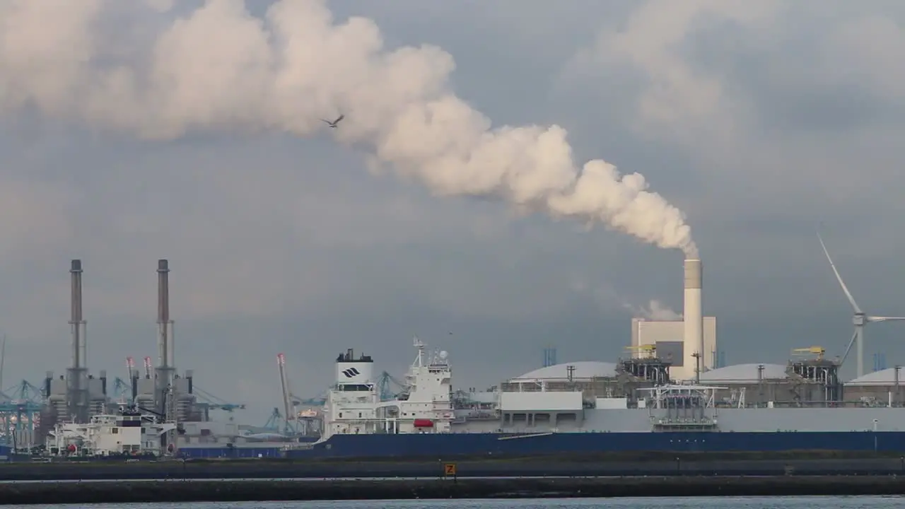 Commercial docks with chimney emitting steam or smoke