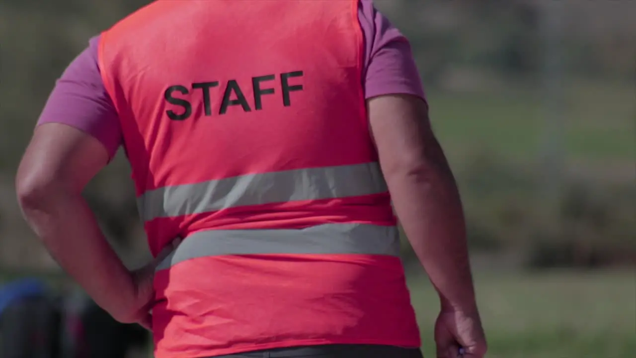 "Staff" writing on the back of a staff member securing a public event