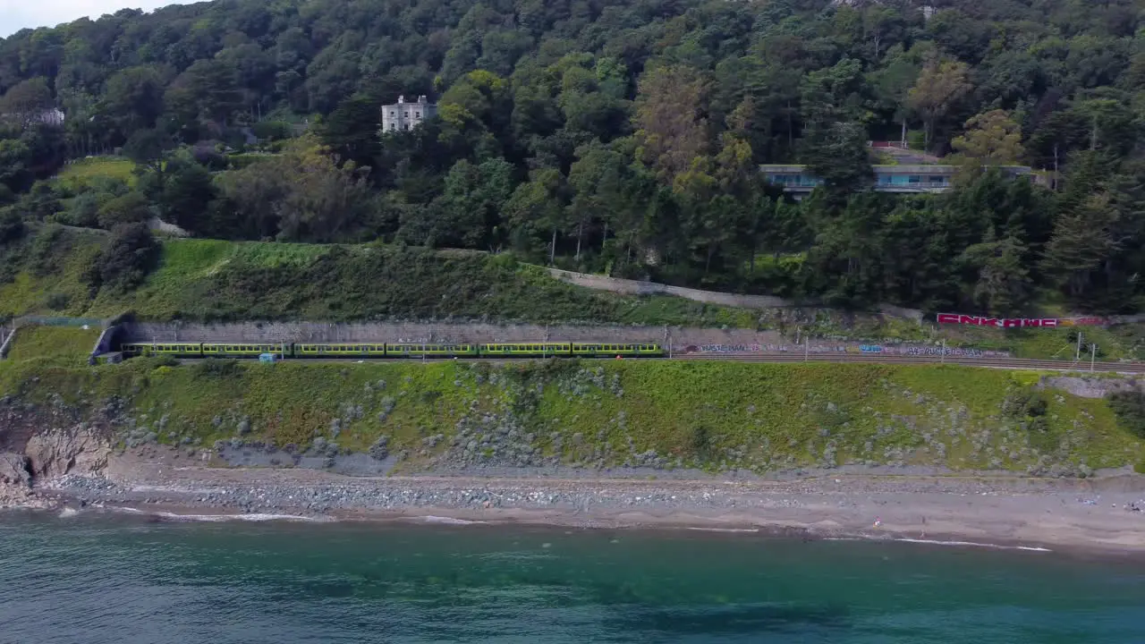 Aerial Shot of a Train Riding by the Irish Coastline in Ireland