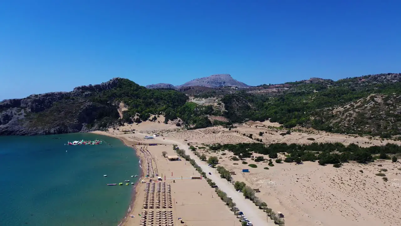 Tsambika beach in Faliraki Rhodes in Greece filmed with the drone from above with Mediterranean Sea in the summer holiday