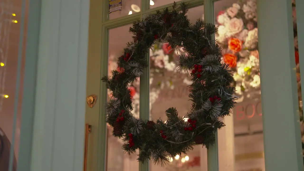 Christmas red berry wreath hanging on a door