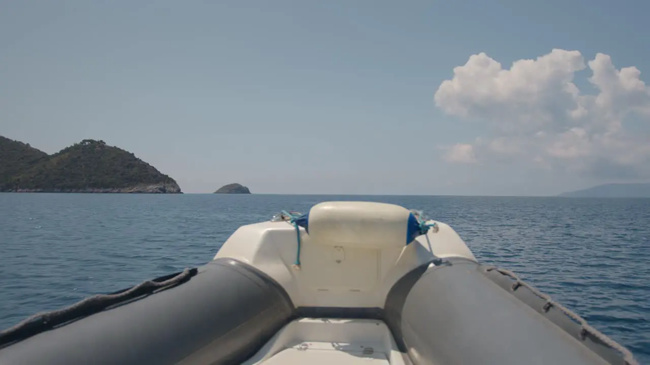 view from a small boat to an island at the sea around monte Argentario