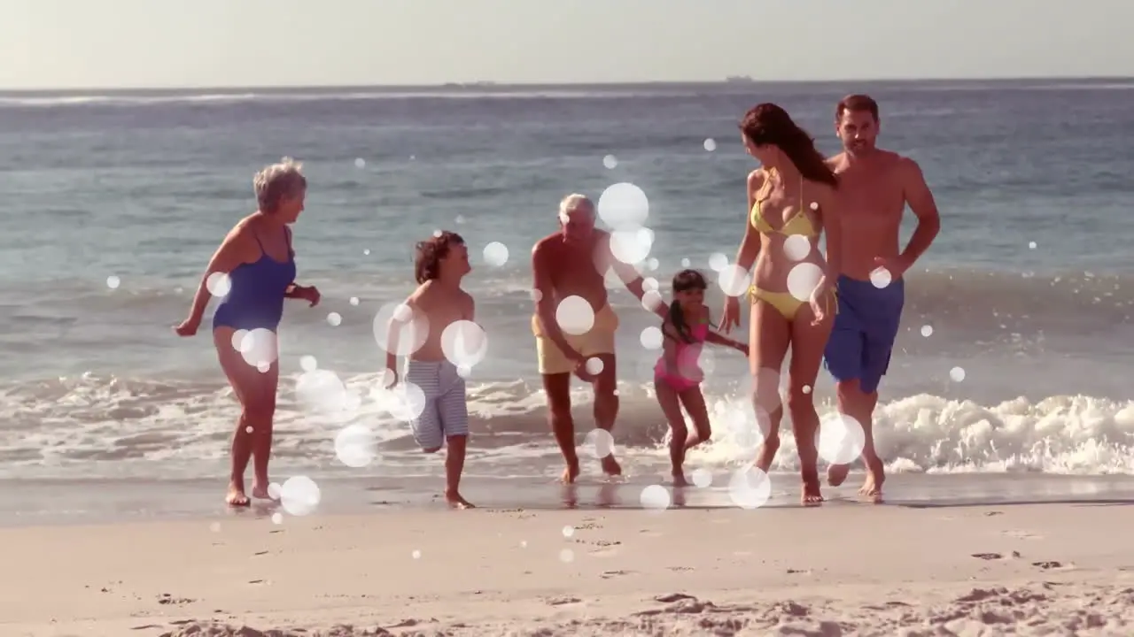 Moving spots of white light with family on beach