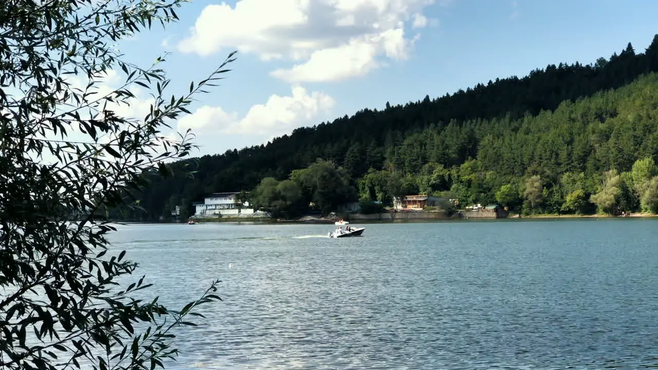 Pancharevo lake during a sunny day with a sailboat moving on the lake