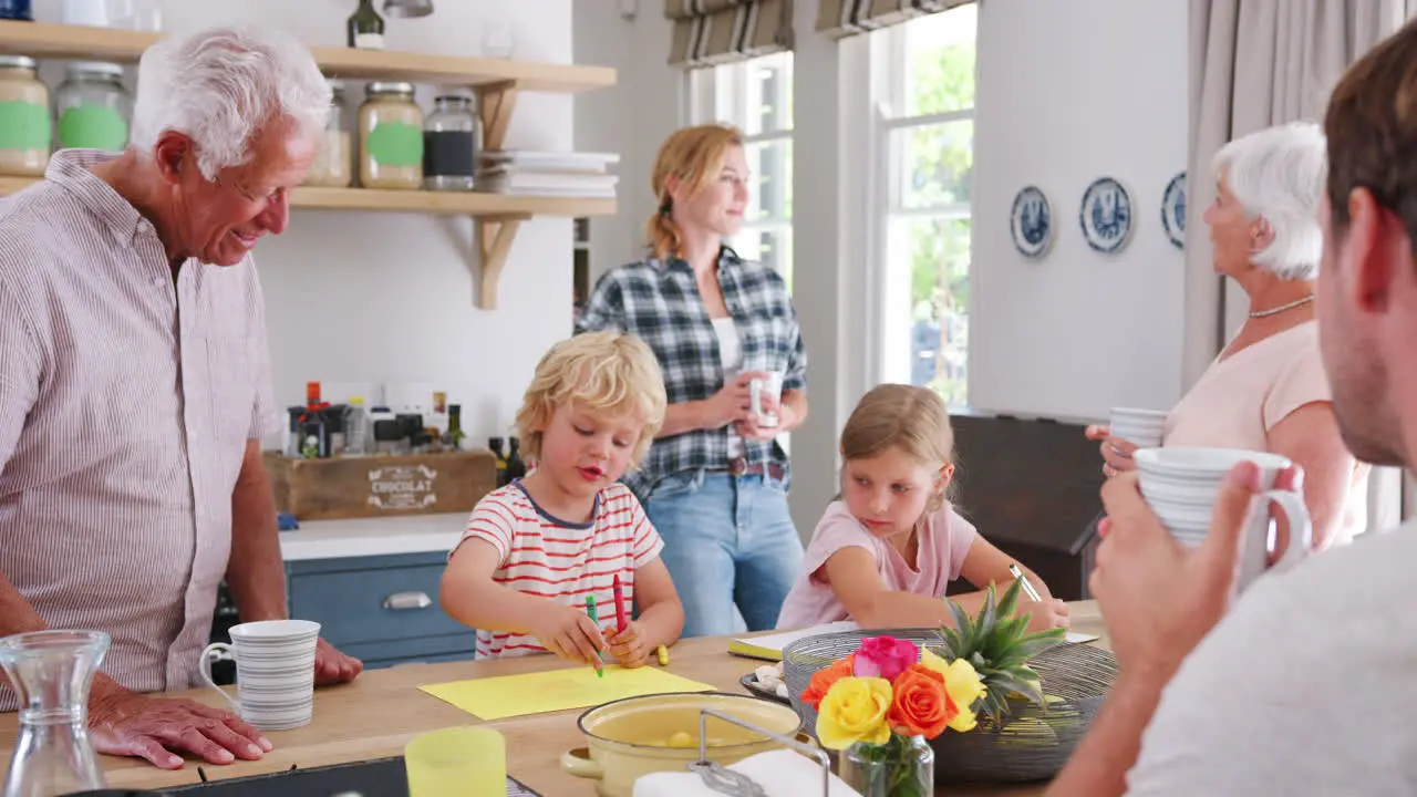 Multi generation family talking at home in their kitchen