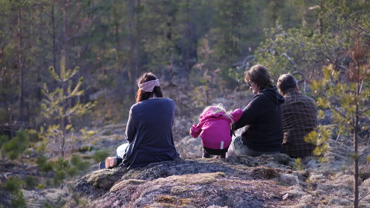 Hiking family taking a picnic break on a mountain