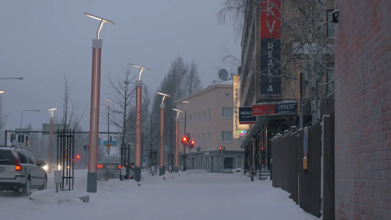 Snowy street with cars on the road in Rovaniemi Finland