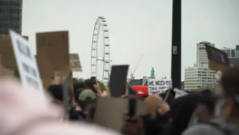 London Crowd of Protesters March With London Eye in Distance