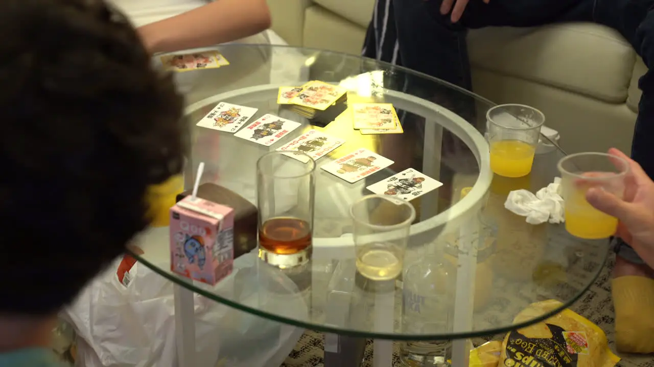 Group of unidentifiable asian young people playing cards