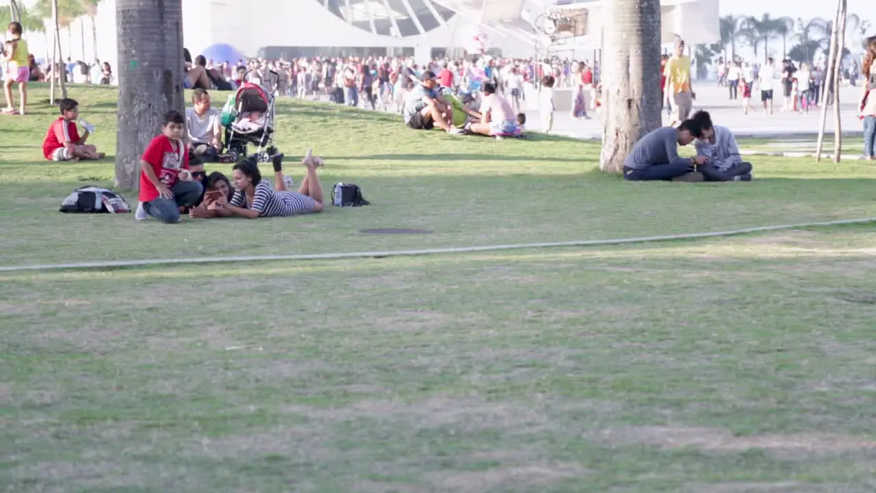 People chilling in front of Museu do Amanha Tomorrow's museum at Praca Maua in Rio de Janeiro Brazil