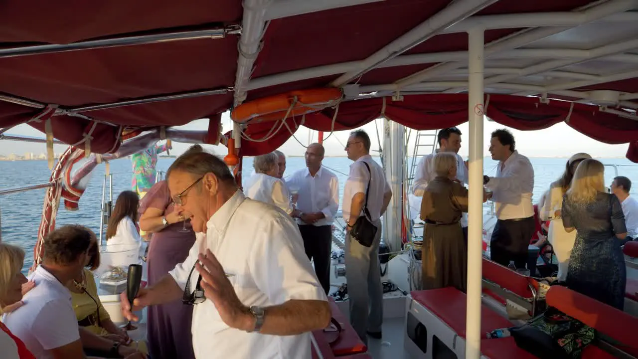 A lot of guests in a wedding party on the ocean 