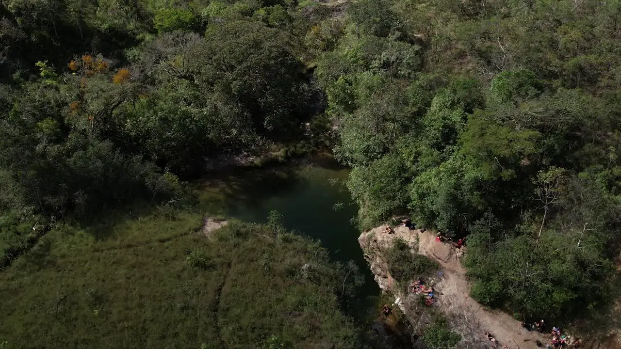 aerial view of Poço das Esmeraldas in Chapada dos Veadeiros Goiás Brazil green water sunny day waterfall rocks and cerrado vegetation