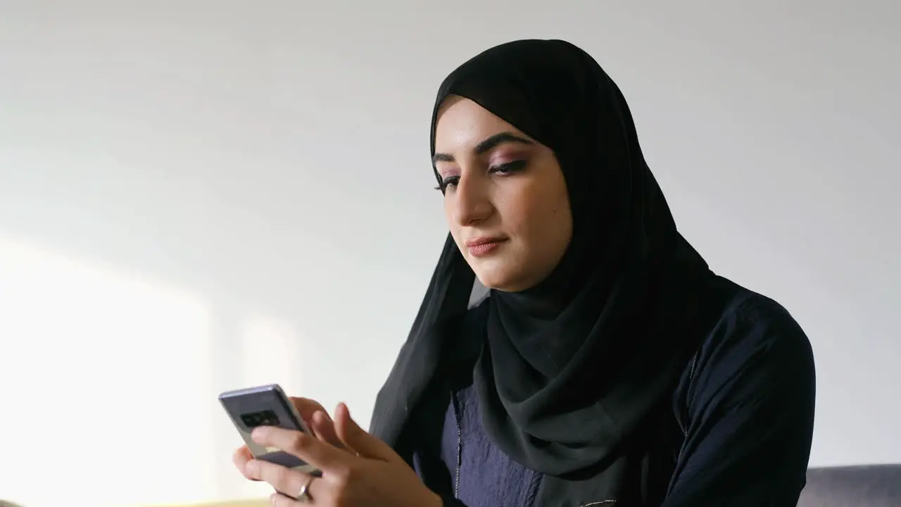 Arab woman using mobile app on her smart cellular phone