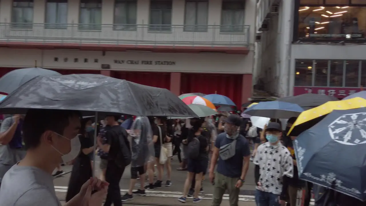 Slow Pan as protesters open umbrellas in unison Hong Kong