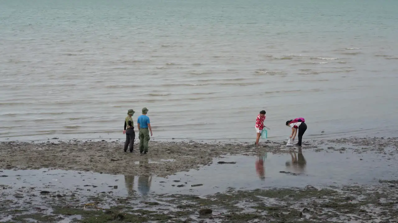 Group of people cleaning beach at Changi Beach Singapore