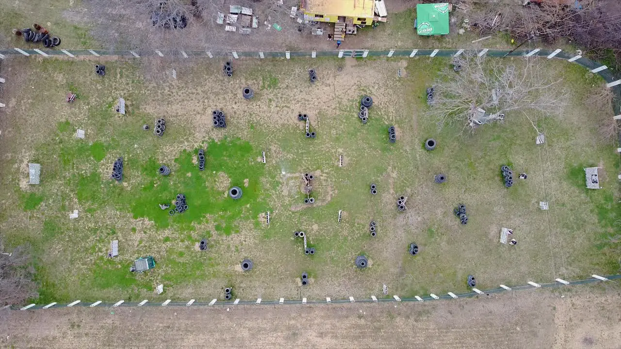 Drone shot of paintball players playing a game of paintball on the field