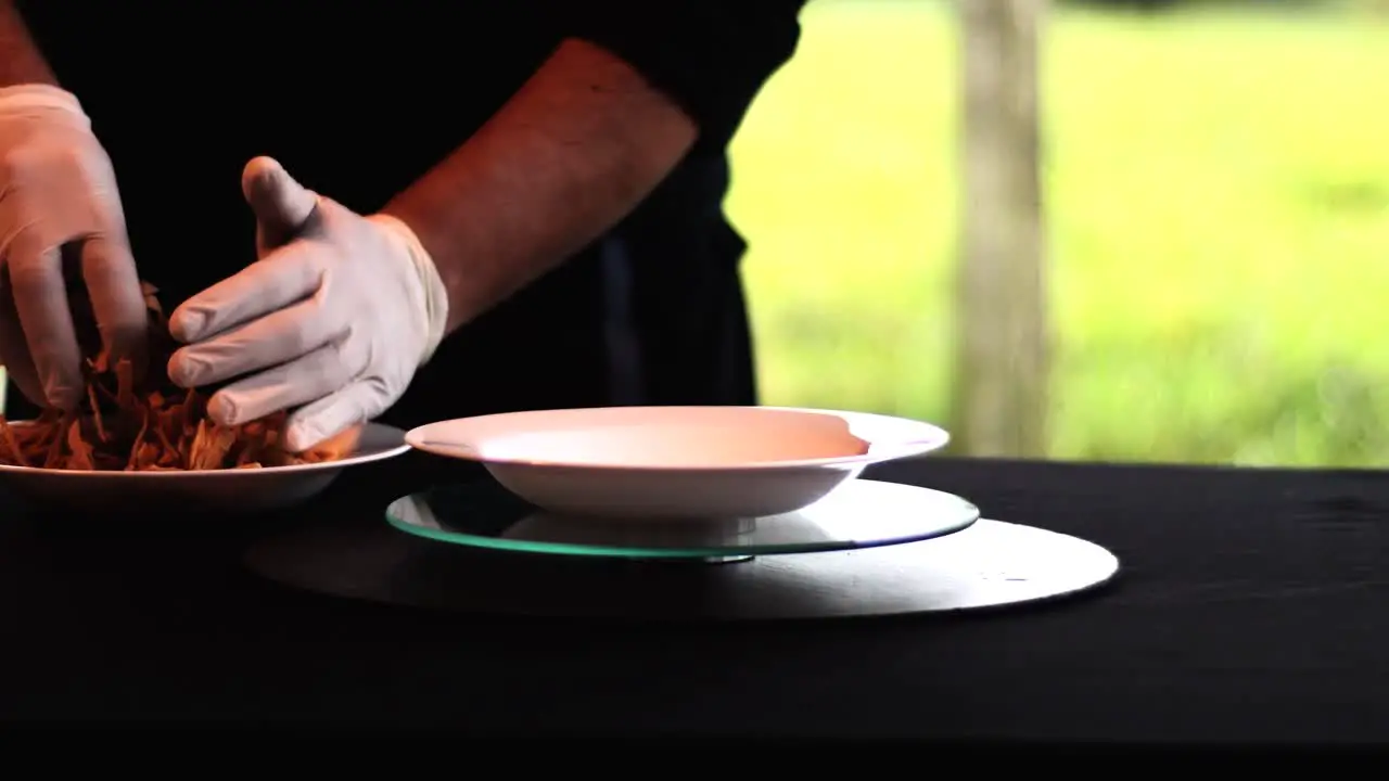 Hands putting corn tortilla chips in a soup bowl