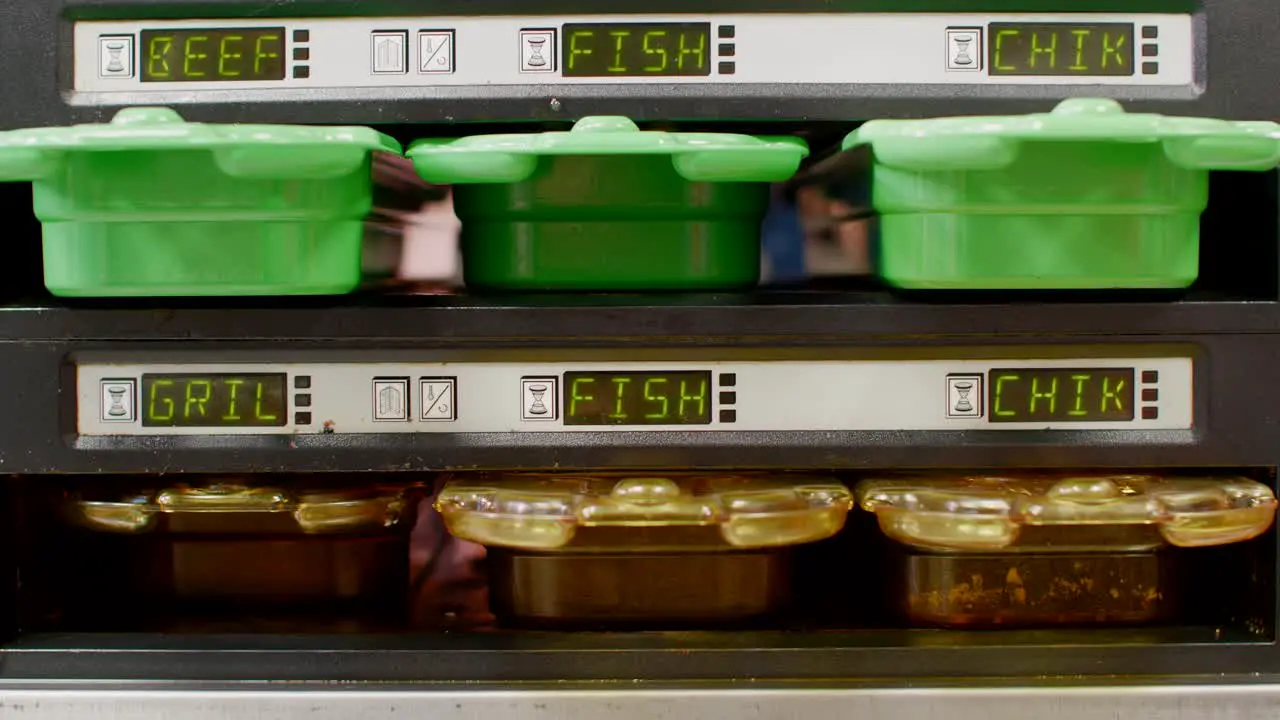 Heat containers with different labels handled in fast food kitchen