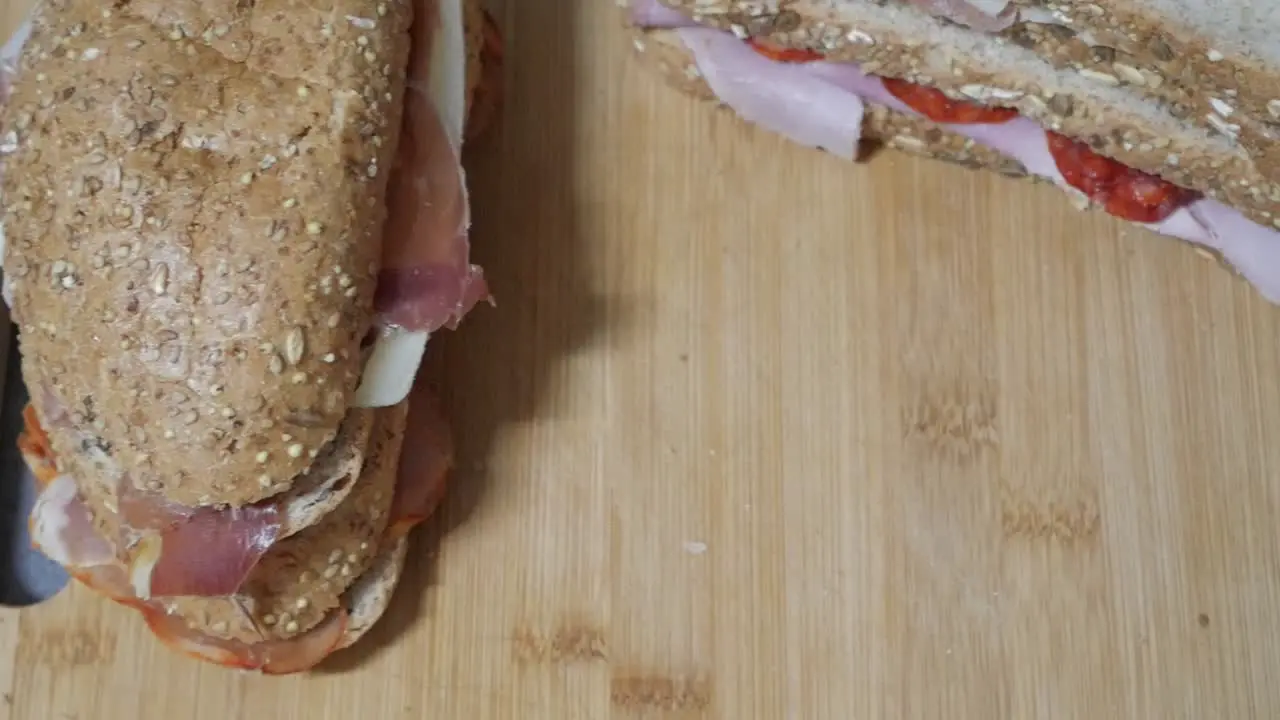 Panning shot sandwiches on wooden cutting board and plate