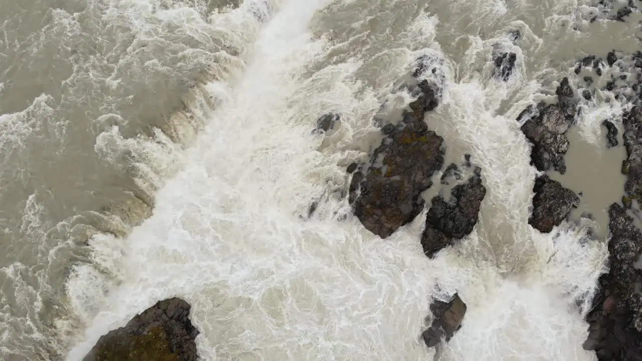 Top down aerial shot of waterfull in Iceland during grey weather