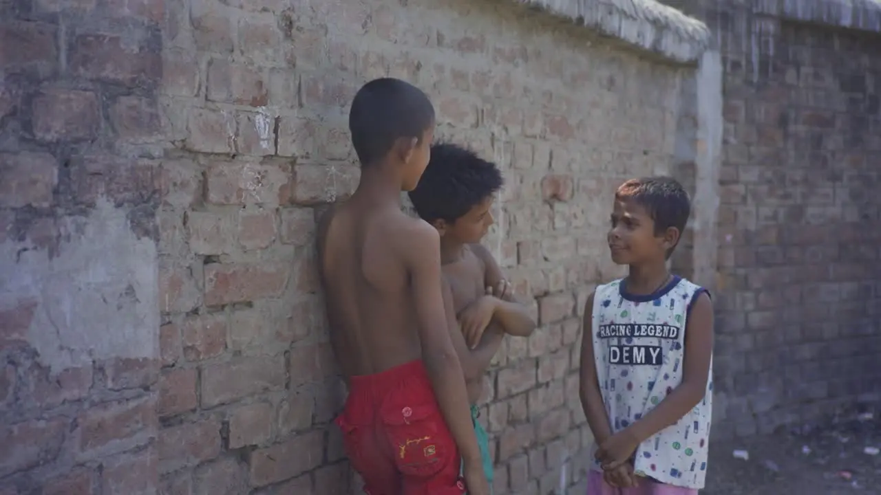 Poor Indian children chatting with their friends outside childhood and friendship of poor orphan children