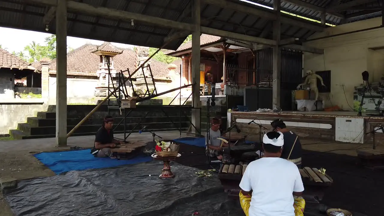 Gamelan Music Teacher Shows How to Play Music in Bali Indonesia wearing Traditional Clothes Sidemen Village