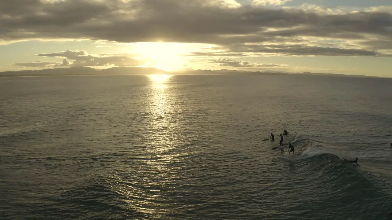 4k Drone shot of two surfers riding a wave together