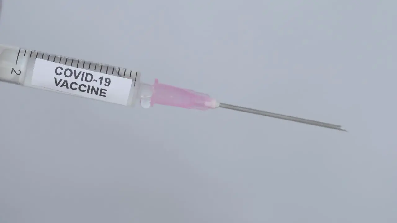 Uncapping a syringe with a Corona Virus Vaccine -close up