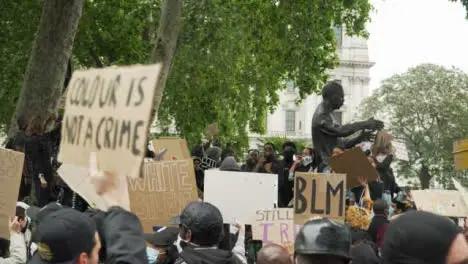 London Black Lives Matter Protester Holds Sign Amongst Chanting Crowds