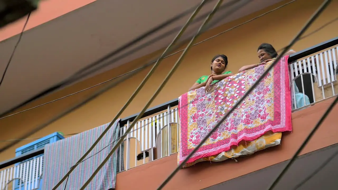 Indian Girl and Woman Talking on a Balcony