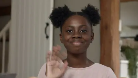 Young Girl Talking and Waving Goodbye During Video Call