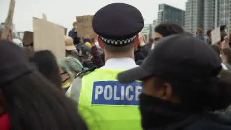 London Protesters Walk Past Police Officer During March