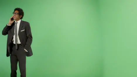 Angry Businessman talking on phone with green screen