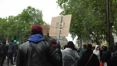 London Black Lives Matter Protester Marches Holding Anti-Racism Sign