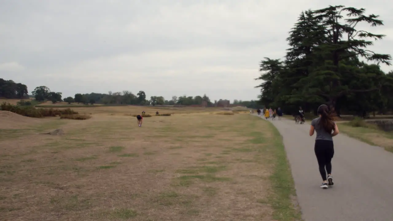 A woman jogging along a path at Bradgate park in England