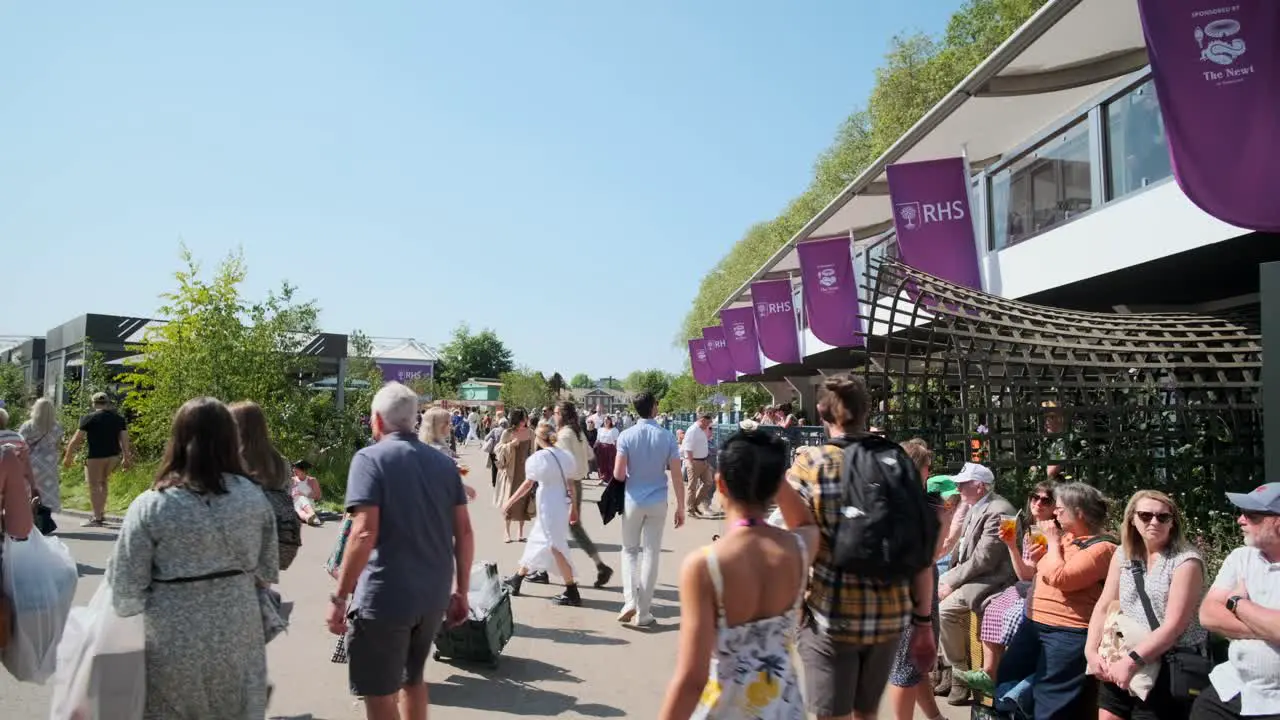 People walking around on a hot summer day at the chelsea flower show