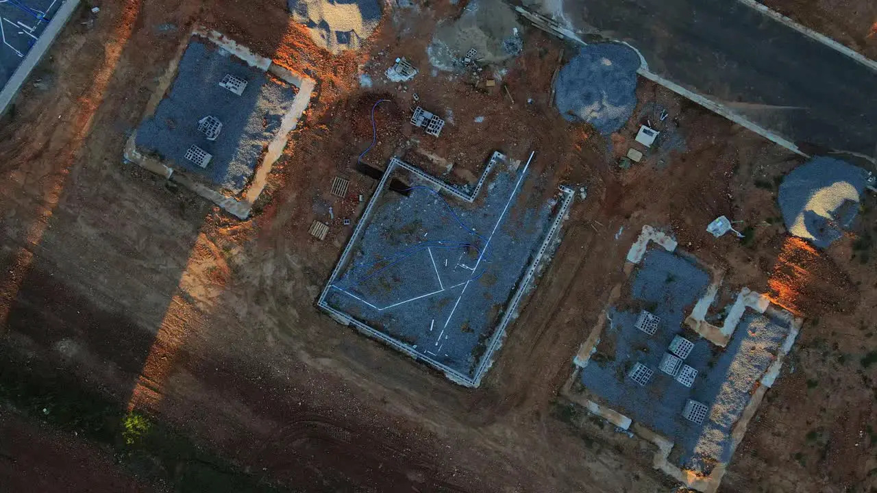 Rising overhead aerial shot of foundation of new home construction