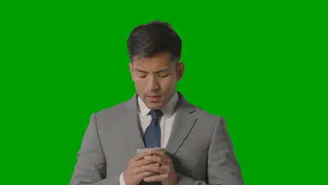 Studio Shot Of Businessman In Suit Holding Cup Of Hot Drink Against Green Screen 1