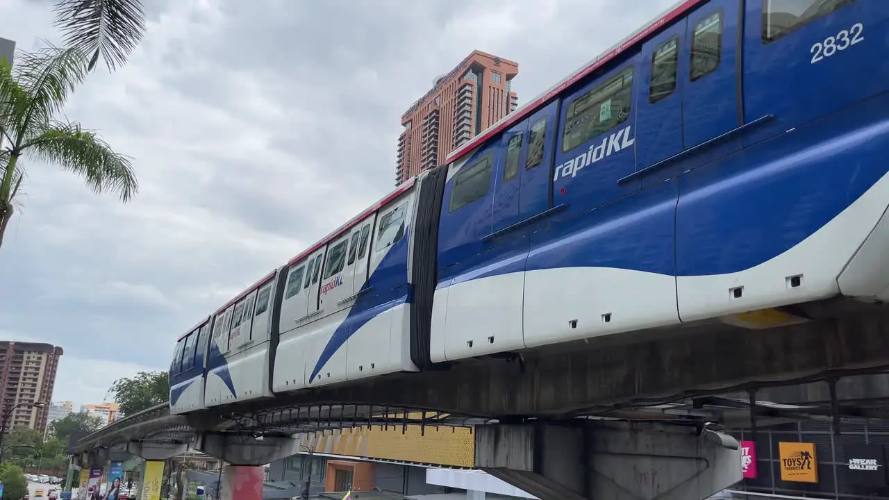 Rapid KL Monorail leaving Bukit Bintang station against the background of Berjaya Times Square in Kuala Lumpur Malaysia