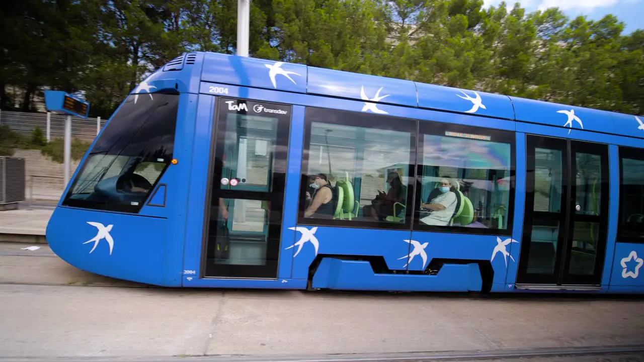 Station with arriving blue public transportation tram recorded at Les Hauts de Massane neighborhood in Montpellier France