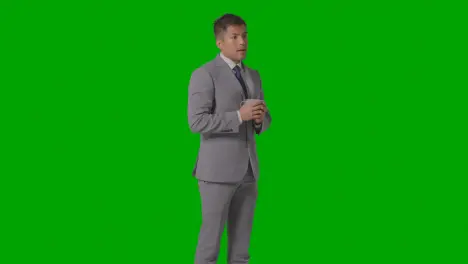 Studio Shot Of Businessman In Suit Holding And Drinking Cup Of Hot Drink Against Green Screen 3