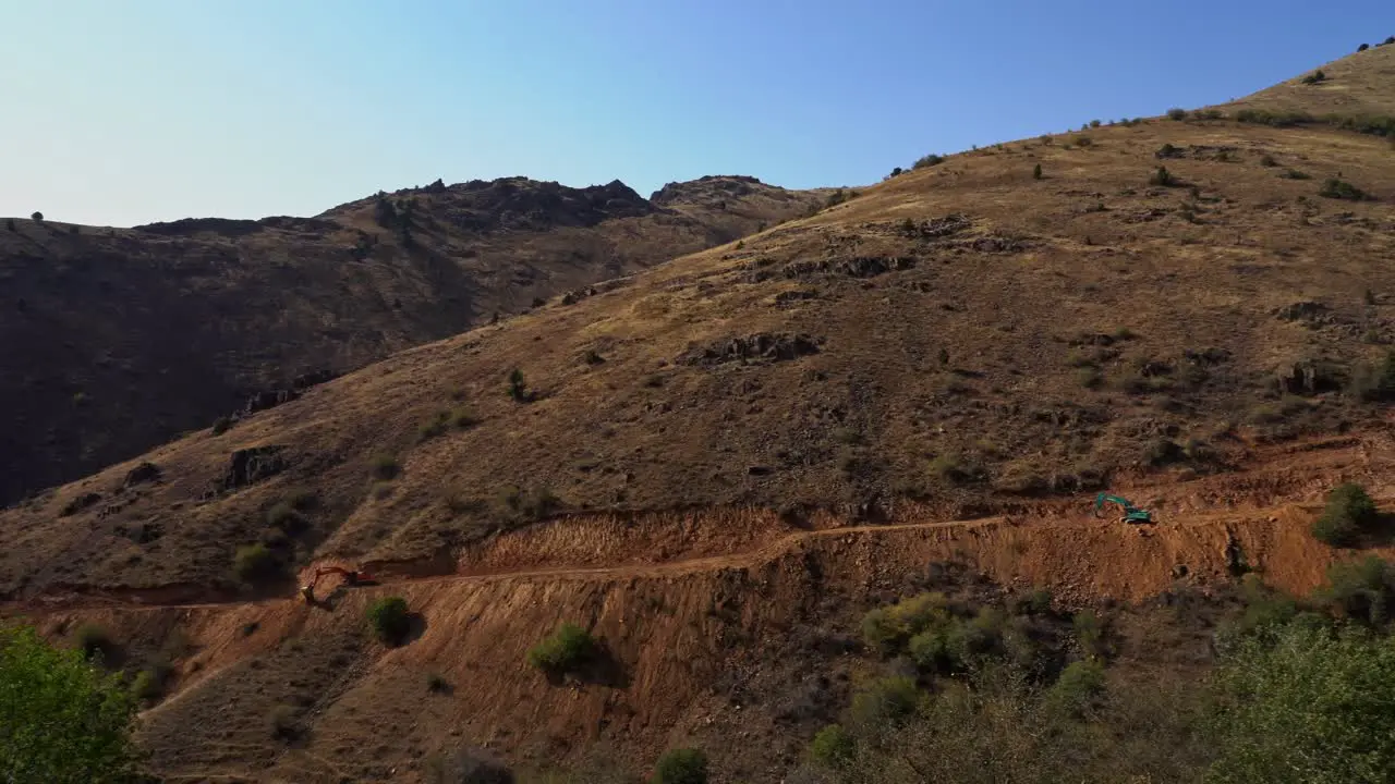 Construction bulldozer and tracked excavator on the mountain