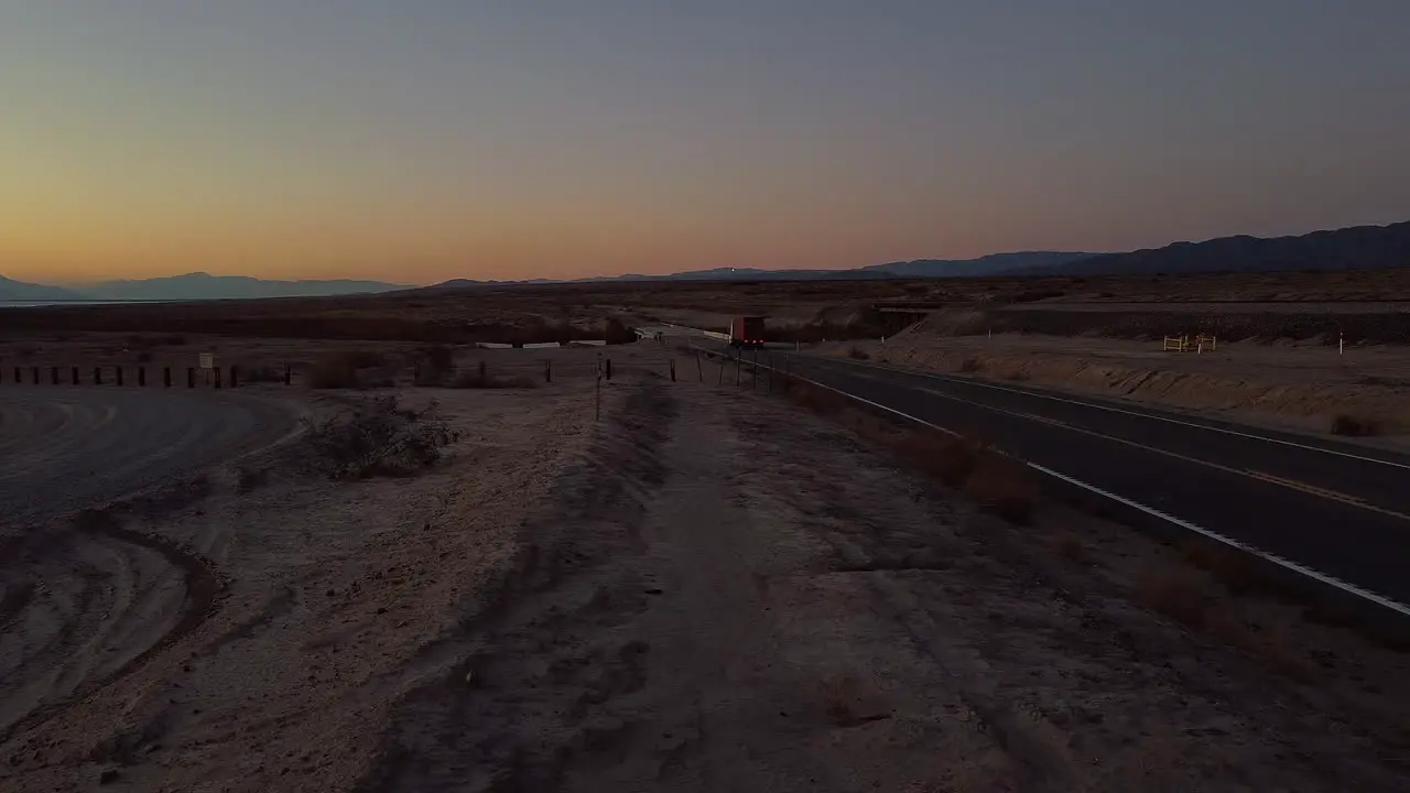 Trucking with Cargo on Freeway in Salton Sea Desert with Glowing Sky at Dusk  California static