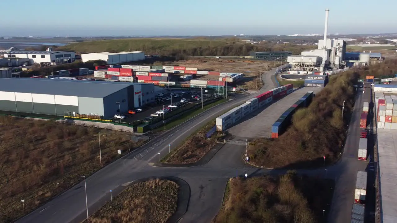 Riverside shipping container warehouse distribution companies aerial view panning left