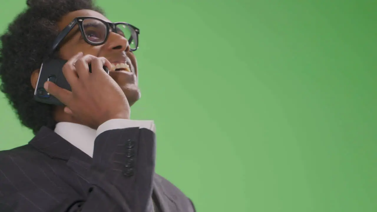 Happy Businessman talking on phone on green screen Low Angle