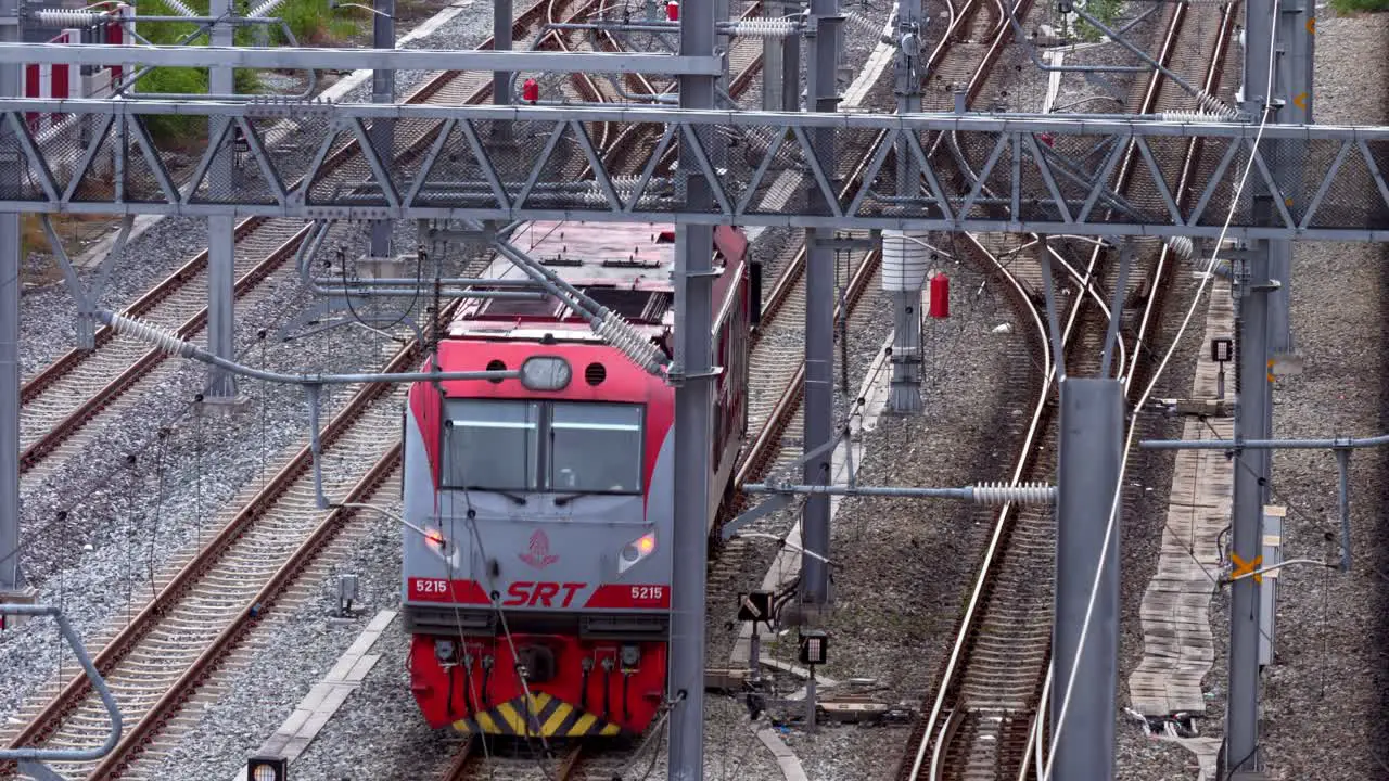 A single train car moving up from the bottom and making a slight turn to the left upper side of the frame located at Bang Sue station in Bangkok Thailand