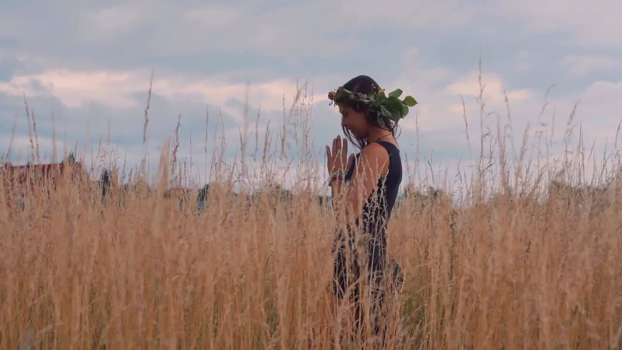 Sexy Hippie woman doing meditation and yoga in the nature in slow motion